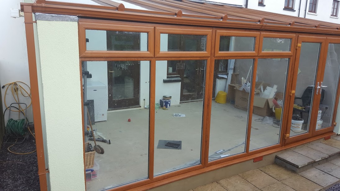 Oak-effect framed sun room with glazed walls, before the interior is finished
