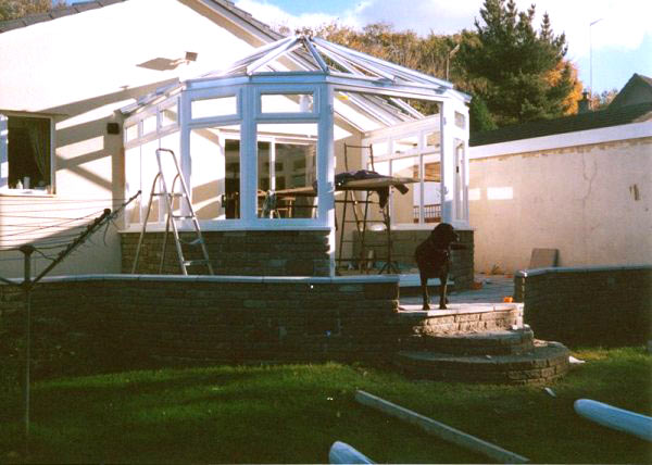 White conservatory frame going up on a brick base
