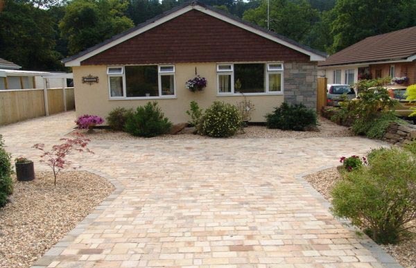 Block-paved driveway in front of a bungalow with planted borders