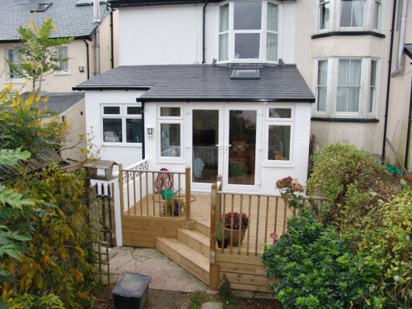 Rear extension with french doors opening onto timber decking and steps