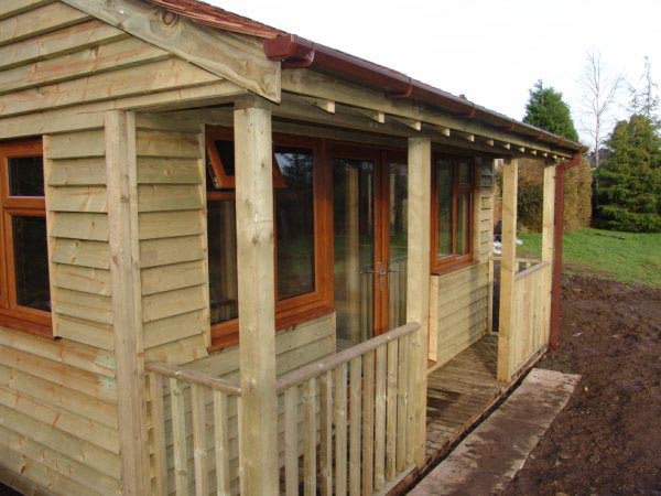 Close view of a garden room veranda and feather-edge cladding