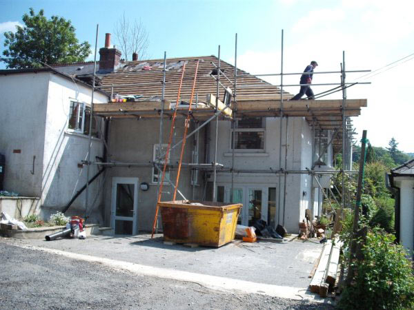 House under scaffolding during a loft conversion