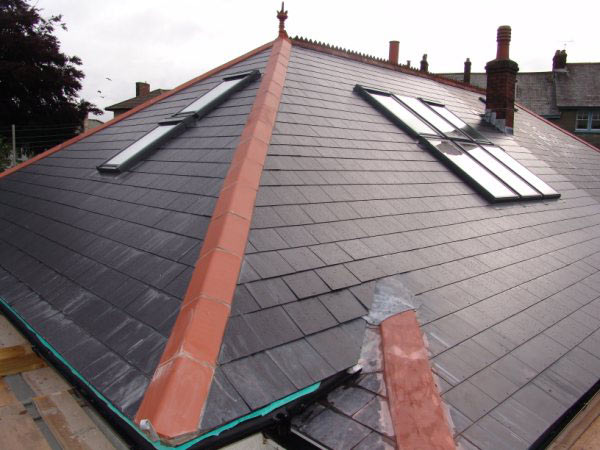 Slate roof with three new roof windows over a loft conversion
