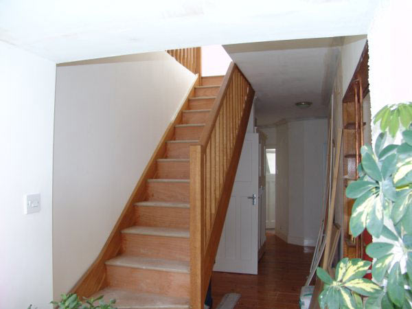 New timber staircase rising to a converted loft