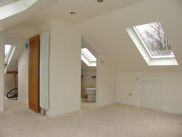 Finished loft room with roof windows and an en-suite door